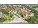 View of complex entrance with mature trees and professional landscaping in a community at 12220 Wild Iris Way # 103, Orlando, FL 32837