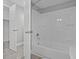Bathroom featuring a tub and shower combination with white tile surround and new fixtures at 123 Tuxpan Ln, Kissimmee, FL 34743