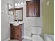 Bathroom features a dark-wood vanity, neutral wall, and light-green tile shower and tub at 123 Tuxpan Ln, Kissimmee, FL 34743