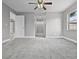 Spacious primary bedroom featuring neutral carpet and ceiling fan with lighting at 123 Tuxpan Ln, Kissimmee, FL 34743