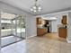 Dining room open to kitchen with tile floors, and access to screened-in patio at 123 Tuxpan Ln, Kissimmee, FL 34743