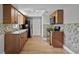 Functional kitchen with wood cabinets, laminate floors, and matching appliances at 123 Tuxpan Ln, Kissimmee, FL 34743