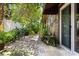 Serene back yard with lush greenery, stone pathway, and a cozy seating area for relaxing outdoors at 1247 Rosemary Dr, Orlando, FL 32807