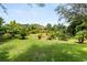 Lush backyard with well-maintained lawn and vibrant landscaping creating a private oasis for outdoor enjoyment and relaxation at 1247 Rosemary Dr, Orlando, FL 32807