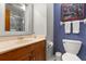 Bathroom features a vanity, sink, toilet, and a shower with a marble-look surround at 1247 Rosemary Dr, Orlando, FL 32807