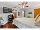 Bedroom with hardwood floors, ceiling fan, and a TV for relaxed viewing at 1247 Rosemary Dr, Orlando, FL 32807