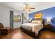 Bedroom with hardwood floors, a comfortable bed, and natural light from a window at 1247 Rosemary Dr, Orlando, FL 32807