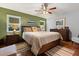 Cozy bedroom with a ceiling fan, hardwood floors, and warm, inviting decor at 1247 Rosemary Dr, Orlando, FL 32807