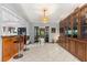 Open living space with tile and hardwood flooring, featuring a built-in bar and views to the kitchen at 1247 Rosemary Dr, Orlando, FL 32807