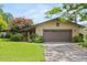 Charming single story home featuring an attached two car garage and a well manicured front lawn at 1247 Rosemary Dr, Orlando, FL 32807