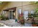 Exterior view with modern solar panels, sliding glass doors, potted plants, and rock garden enhancing the home's curb appeal at 1247 Rosemary Dr, Orlando, FL 32807
