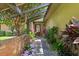 Inviting front entrance featuring a brick wall, walkway, and colorful plants, adding to the home's curb appeal at 1247 Rosemary Dr, Orlando, FL 32807