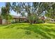 Well-maintained front yard with lush green lawn, mature trees, and charming curb appeal enhancing the home's exterior at 1247 Rosemary Dr, Orlando, FL 32807