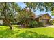 Inviting home exterior surrounded by flowering trees and lush landscaping, offering great curb appeal at 1247 Rosemary Dr, Orlando, FL 32807