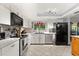 Bright kitchen with white countertops, stainless steel appliances, tile floors and plenty of storage space at 1247 Rosemary Dr, Orlando, FL 32807