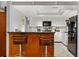 Bright kitchen with granite countertops, wooden breakfast bar, stainless steel appliances and white cabinetry at 1247 Rosemary Dr, Orlando, FL 32807
