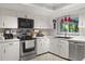 Bright kitchen with white countertops, stainless steel appliances, tile floors and a window above the sink at 1247 Rosemary Dr, Orlando, FL 32807