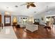 Spacious living room featuring hardwood floors, bright windows, and designer ceiling fans at 1247 Rosemary Dr, Orlando, FL 32807
