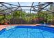 A screened-in pool area with a luxurious pool, hot tub, and plenty of space for relaxing and enjoying the outdoors at 1247 Rosemary Dr, Orlando, FL 32807
