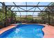 A screened-in pool area with a luxurious pool, hot tub, and plenty of space for relaxing and enjoying the outdoors at 1247 Rosemary Dr, Orlando, FL 32807