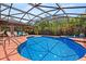 A screened-in pool area with a luxurious pool, hot tub, seating, and plenty of space for relaxing and enjoying the outdoors at 1247 Rosemary Dr, Orlando, FL 32807