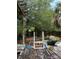View of the backyard with a wooden deck, ladder, plants, and an old weathered fence at 128 N Sunland Dr, Sanford, FL 32773