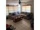 Cozy living room featuring a large sectional sofa, ceiling fan, and lots of natural light at 128 N Sunland Dr, Sanford, FL 32773