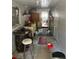Enclosed patio features white walls and ceiling, an overhead light, and access to the backyard at 128 N Sunland Dr, Sanford, FL 32773