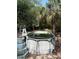 Above-ground pool surrounded by trees and a palm, with a ladder and steps leading to the water at 128 N Sunland Dr, Sanford, FL 32773