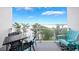 Balcony with stylish seating, lake view and white metal railing at 13427 Blue Heron Beach Dr # 306, Orlando, FL 32821
