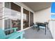 Balcony with stylish seating, lake view, white metal railing and sliding glass doors at 13427 Blue Heron Beach Dr # 306, Orlando, FL 32821