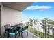 Balcony with stylish seating, lake view and white metal railing at 13427 Blue Heron Beach Dr # 306, Orlando, FL 32821