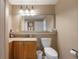 Bathroom features a granite countertop, large mirror, neutral paint, and tile floors at 13427 Blue Heron Beach Dr # 306, Orlando, FL 32821