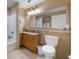 Bright bathroom offers a shower-tub combo, large mirror, tile floors, and storage space at 13427 Blue Heron Beach Dr # 306, Orlando, FL 32821