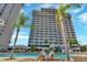 Luxurious high-rise building showcasing an expansive pool and sunbathing area at 13427 Blue Heron Beach Dr # 306, Orlando, FL 32821