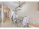 Bright dining area featuring a glass-top table and white chairs, with views into the hallway and kitchen at 13427 Blue Heron Beach Dr # 306, Orlando, FL 32821
