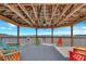 Interior view of the gazebo, showcasing multiple Adirondack chairs and stunning lake scenery at 13427 Blue Heron Beach Dr # 306, Orlando, FL 32821