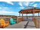 Relaxing lakeside gazebo featuring Adirondack chairs and picturesque water views at 13427 Blue Heron Beach Dr # 306, Orlando, FL 32821