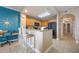 Charming kitchen with bar seating, wood cabinets, black appliances, and a decorative blue accent wall at 13427 Blue Heron Beach Dr # 306, Orlando, FL 32821