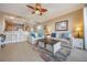 Inviting living area flows into kitchen and dining space, featuring bright and open floorplan with balcony at 13427 Blue Heron Beach Dr # 306, Orlando, FL 32821