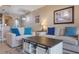 Cozy living room featuring comfortable seating and a rustic coffee table with sliding doors at 13427 Blue Heron Beach Dr # 306, Orlando, FL 32821