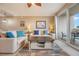 Comfortable living room featuring neutral furnishings, a ceiling fan, and balcony access with scenic views at 13427 Blue Heron Beach Dr # 306, Orlando, FL 32821