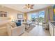 Bright living room featuring tile flooring, comfortable seating, and access to a balcony with great views at 13427 Blue Heron Beach Dr # 306, Orlando, FL 32821
