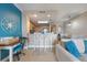 Well-lit living space with a desk, breakfast bar, and view into the kitchen and dining area at 13427 Blue Heron Beach Dr # 306, Orlando, FL 32821