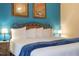 Spacious main bedroom features a cozy king bed with a wrought iron headboard at 13427 Blue Heron Beach Dr # 306, Orlando, FL 32821
