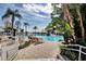 Resort-style pool area with tropical landscaping and comfortable lounge chairs at 13427 Blue Heron Beach Dr # 306, Orlando, FL 32821