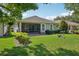 Charming backyard featuring a screened porch and well-maintained lawn with elegant landscaping at 1386 Longley Pl, Deland, FL 32724
