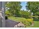 Lush backyard featuring manicured lawn, elegant landscaping, and a pond view, ideal for outdoor enjoyment at 1386 Longley Pl, Deland, FL 32724