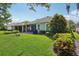 Spacious backyard featuring a lush lawn, elegant landscaping, and a screened porch perfect for outdoor living at 1386 Longley Pl, Deland, FL 32724