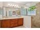 Bright bathroom featuring a large vanity, dual sinks, and a walk-in shower at 1386 Longley Pl, Deland, FL 32724
